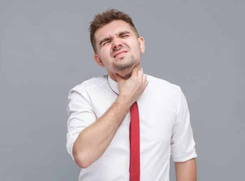 Throat pain. man touching his painful neck.